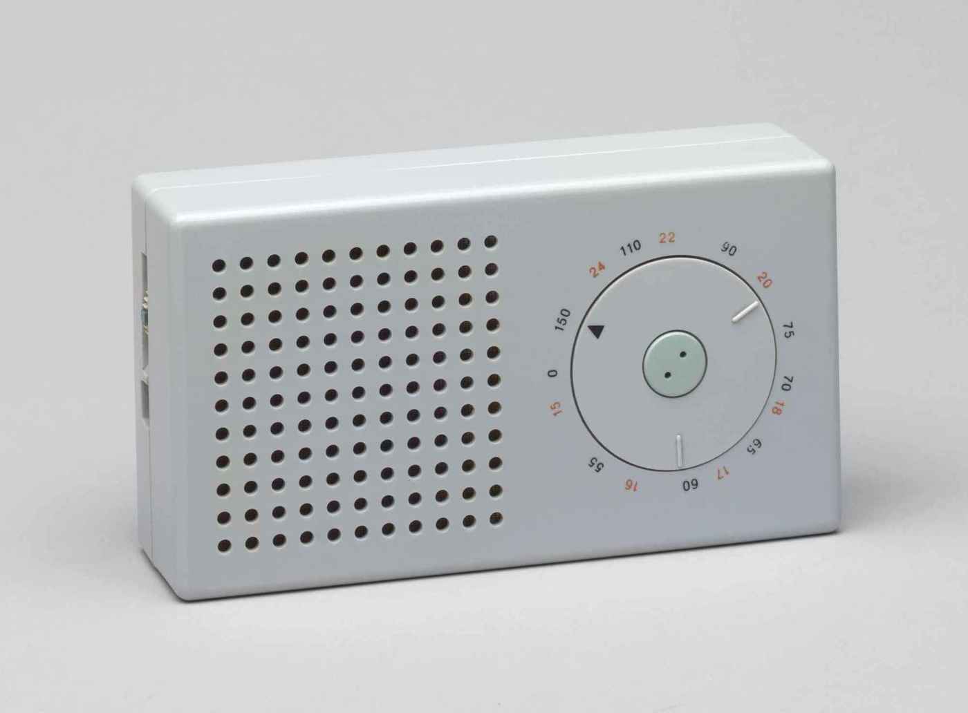 The iconic Braun T3 pocket transistor radio, designed by Dieter Rams (195866ya; MoMA photo); though somewhat faded, the red (one of only 3 colors on the device) numerals still clearly denote longwave radio frequencies (black for medium wave length). It strikingly resembles the Apple iPod, which, however, is all-white.